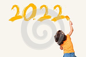Cute little girl drawing new year 2022