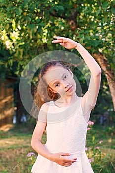 Cute little girl dreams of becoming a ballerina. Child girl in w