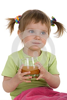 Cute little girl drink carrot juice