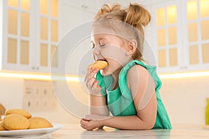 Cute little girl eating cookies