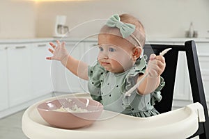 Cute little girl eating healthy food at home