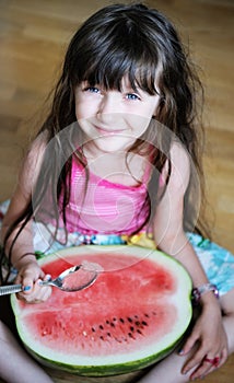 Cute little girl eating watermelon