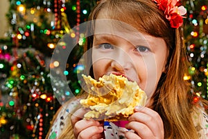 cute little girl eats cake sakotis new year and merry christmas background
