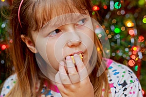 cute little girl eats cake sakotis new year and merry christmas background