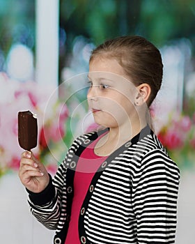 Cute little girl eats ice cream