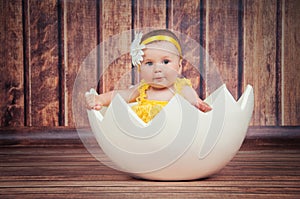 Cute little girl in the egg basket.