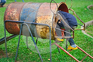 Cute little girl is enjoying the outdoor playground in summer.