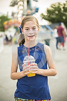 Cute little girl enjoying summer vacation at amusement park