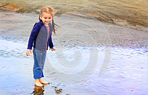 Cute little girl explores beach