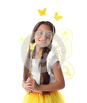 Cute little girl in fairy costume with yellow wings and magic wand on white background