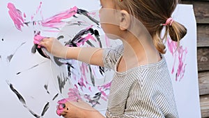Cute little girl finger painting with various colors