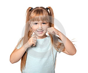 Cute little girl flossing her teeth on white background