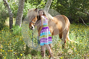 Cute Little Girl Giving her Pony a Snuggle