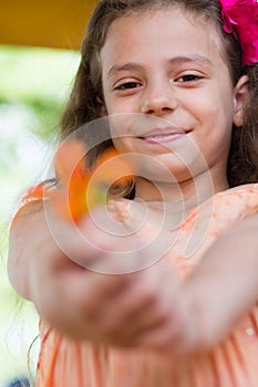 Cute little girl giving you the flower