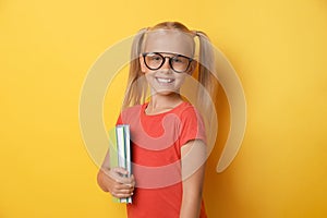 Cute little girl with glasses and books. Reading concept