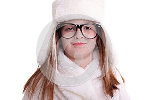 Cute little girl with glasses in warm white hat