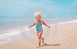 Cute little girl going to swim at beach vacation