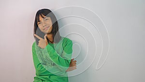 cute little girl in green t-shirt isolated on white background