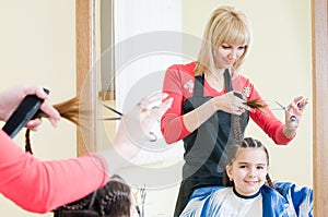 Cute little girl in hairdresser salon