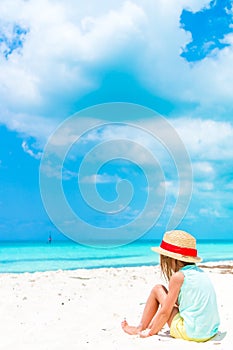 Cute little girl in hat at beach during caribbean vacation