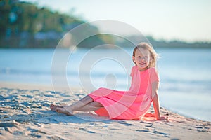 Cute little girl in hat at beach during caribbean vacation