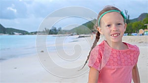 Cute little girl in hat at beach during caribbean vacation