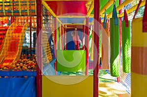 Cute little girl have fun at soft outdoor playground