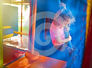 Cute little girl have fun at soft outdoor playground