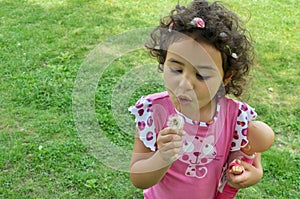 A cute little girl is having fun in a garden