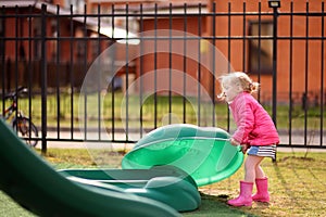 Cute little girl having fun on outdoor playground