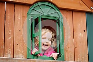 Cute little girl having fun on outdoor playground