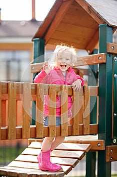 Cute little girl having fun on outdoor playground