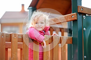 Cute little girl having fun on outdoor playground