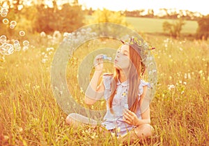 Cute little girl having fun playing with soap bubbles
