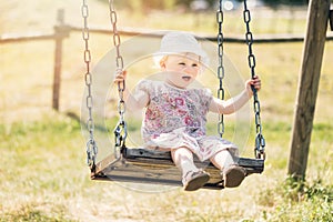Cute little girl having fun on a swing