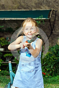 Cute little girl helping her mother in the backyard