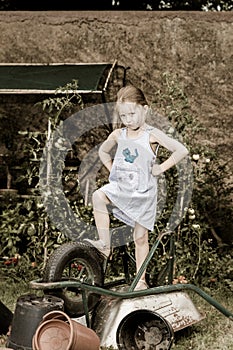 Cute little girl helping her mother in the backyard