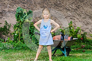 Cute little girl helping her mother in the backyard