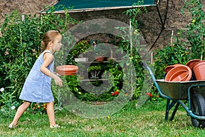 Cute little girl helping her mother in the backyard