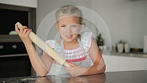 Cute Little Girl Helps Cooking. She`s the Mistress of the Kitchen. Cooking Brings Her A Lot Of Fun.