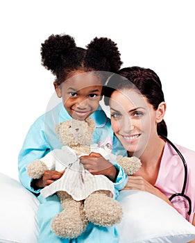 Cute little girl with her doctor smiling