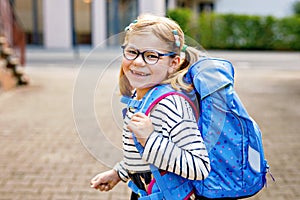 Cute little girl on her first day going to school. Healthy beautiful child walking to nursery preschool and kindergarten