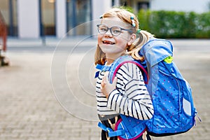 Cute little girl on her first day going to school. Healthy beautiful child walking to nursery preschool and kindergarten