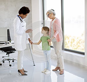 Cute little girl with her grandmother at the pediatrician examination