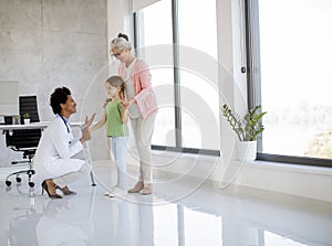 Cute little girl with her grandmother at the pediatrician examination