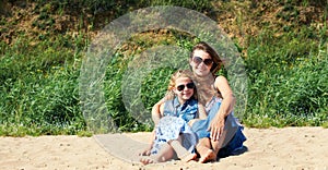 Cute little girl and her mother have a good time at the seaside