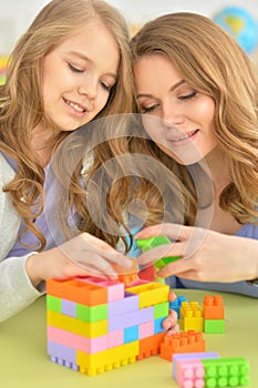 Cute little girl and her mother playing