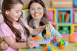 Cute little girl and her mother playing