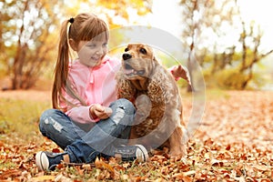 Cute little girl with her pet in park