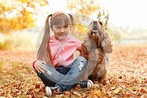 Cute little girl with her pet in park